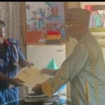 R-L: Toto LGC Executive Chairman, Hon Aliyu Abdullahi Tashas presenting C of O to OC in charge of NSCDC for Toto LGA