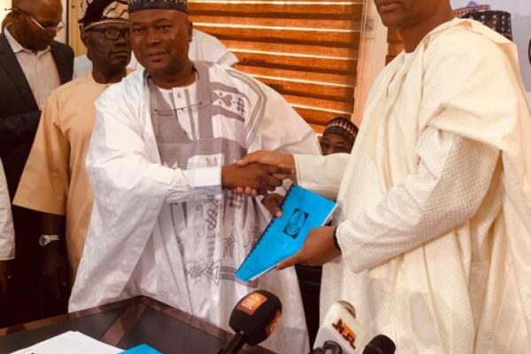 The outgoing Director General, Dr. Nasir Olaitan Raji-Mustapha, and the incoming Director General, Hon. Baffa Babba Dan Agundi, at the handing over ceremony