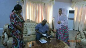 Kogi State Governor Yahaya Adoza Bello presents a ₦33.48 million scholarship award to Fatima Sani, facilitated by Senator Natasha Akpoti, to support her education.