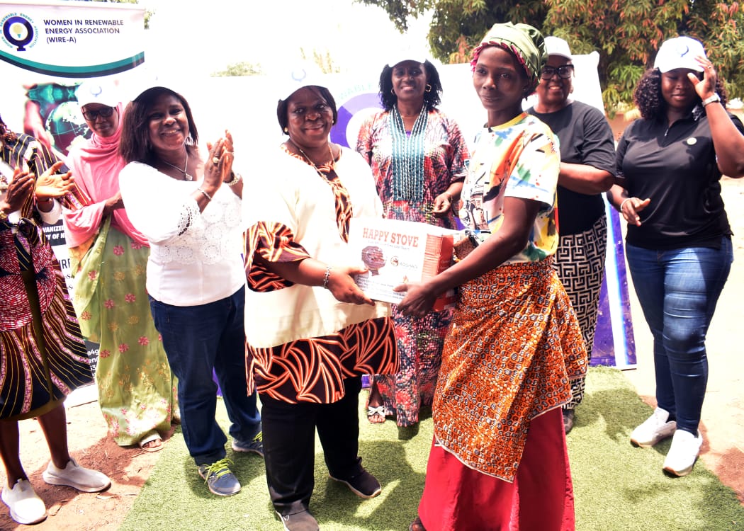 The National Vice President, Women in Renewable Energy -Associations (WIRE-A)Dr. Anita Adeyemi making a presentation to one of the recipients of the Cookstoves at the occasion. Lined up behind her (from left to right)are: National Secretary- Rashida Mahmood, FCT Coordinator - Dr. Adetoun Dally, Kaduna State Coordinator - Vivienne Uzo Iyiegbu, South East Regional Coordinator - Hon. Bridget Obi and Head of Clean Cookstoves- Chibuzor Chidozie .M