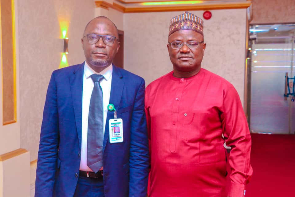 Ibrahim Musa as Clerk and Paul Okugya as Deputy Clerk