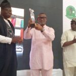 Chief of staff to the FCT Minister Nyesom Wike receive an award of excellence on behalf of the minister