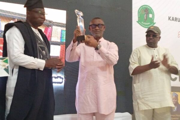 Chief of staff to the FCT Minister Nyesom Wike receive an award of excellence on behalf of the minister