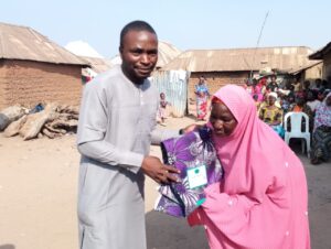 Mr. Theophilus Peter Ewu during the presentation of gifts to one of the beneficiaries.