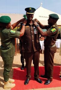 Officer in charge of medium security custodial center Keffi, Ismaila Shekwoyandu Bulus with Dr. NS Yerima decorating an newly promoted officer.