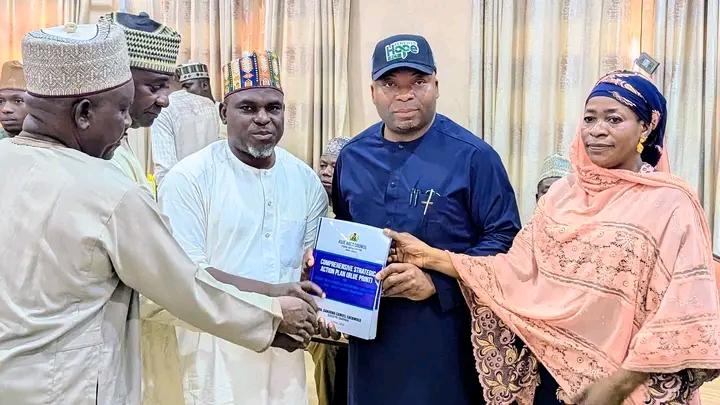 Action planning committee chairman Prof Mohammed Ibrahim Evuti present report to the chairman -elect of Kuje Area Council on Thursday