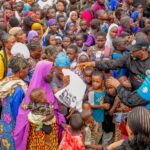 Volunteers distribute free food to vulnerable residents during the APC Youth Network West Africa's weekly humanitarian outreach in Agidingbi, Ikeja, Lagos.