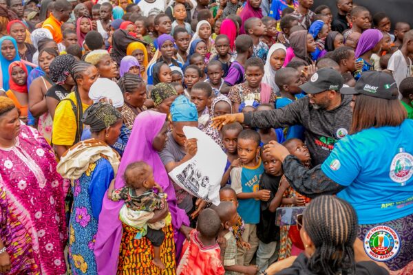 Volunteers distribute free food to vulnerable residents during the APC Youth Network West Africa's weekly humanitarian outreach in Agidingbi, Ikeja, Lagos.