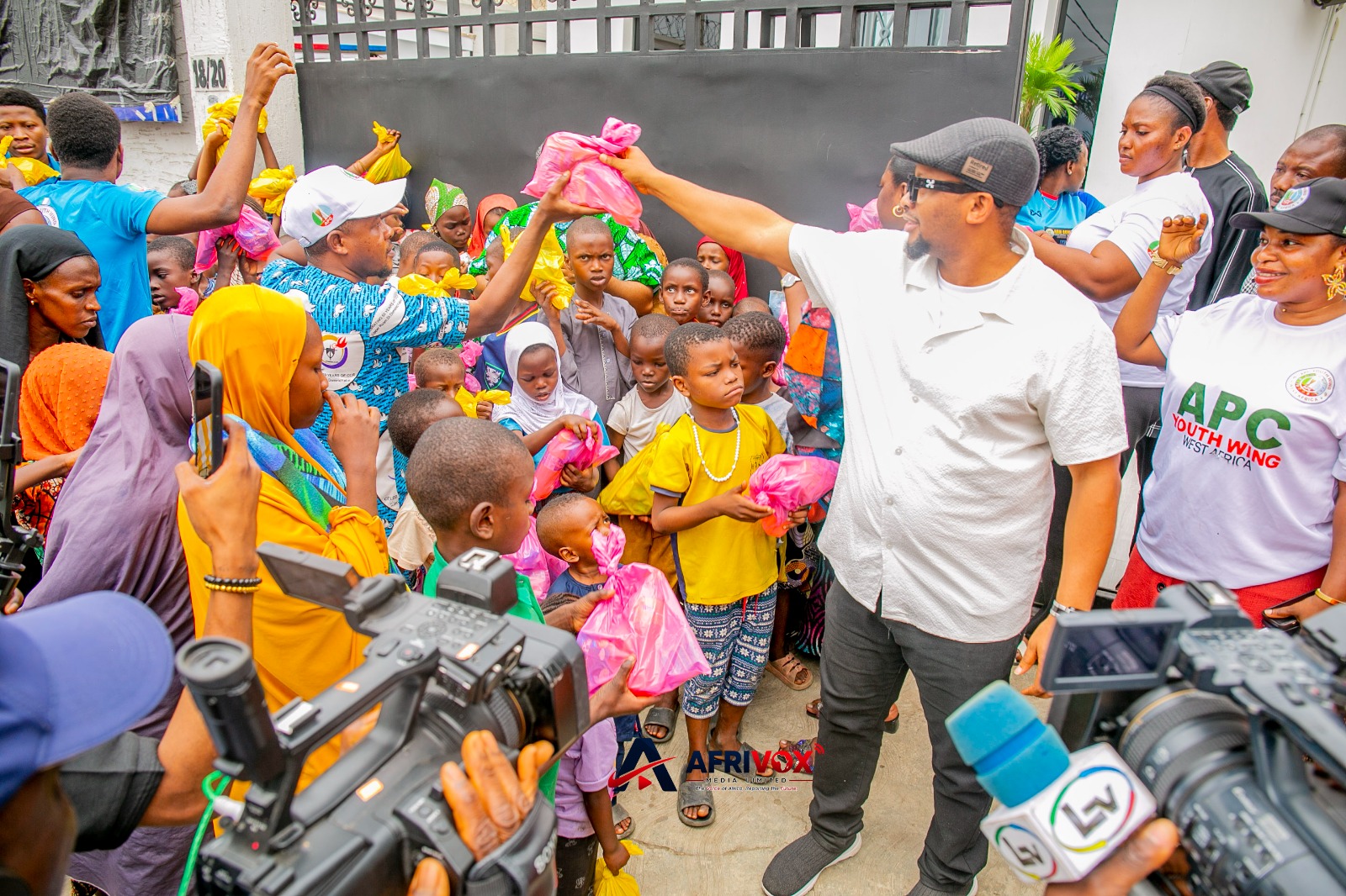 Beneficiaries receiving food during APCYN-WA's weekly humanitarian outreach in Lagos.